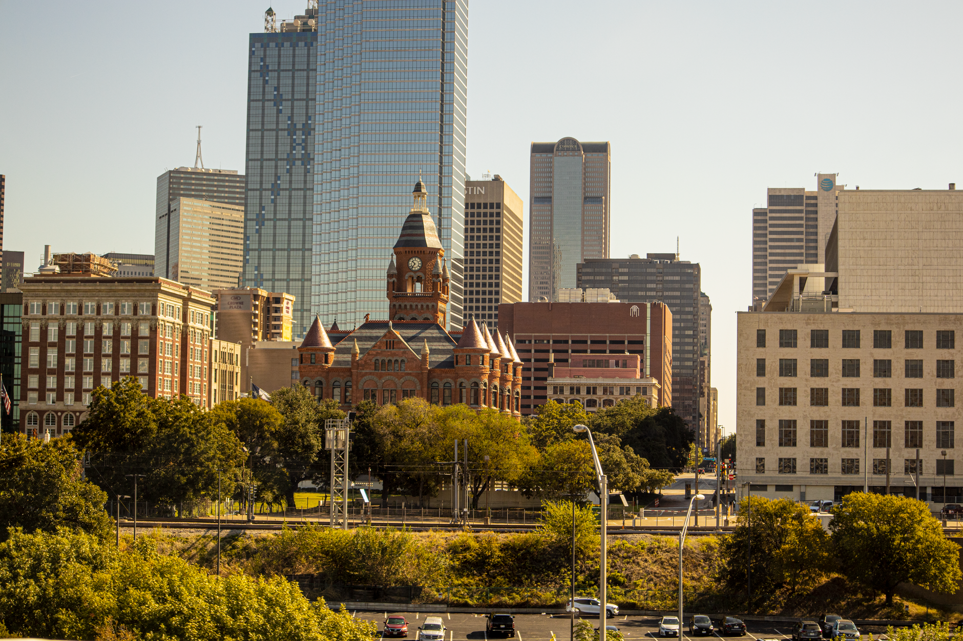 Downtown Dallas skyline with the historic Old Red Courthouse framed by green treetops