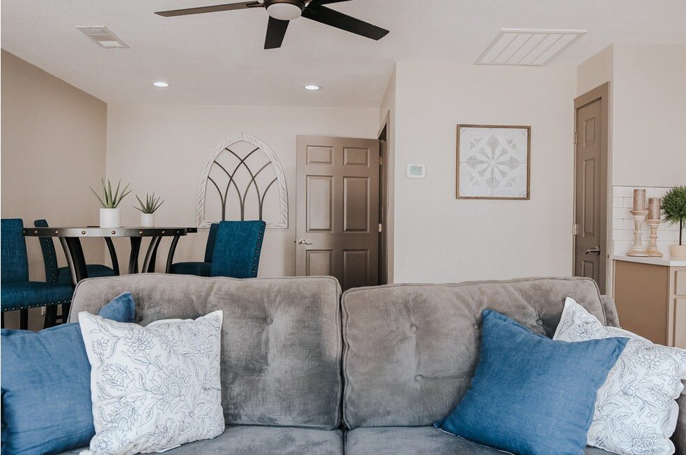 Open-concept living room with sectional seating and an arched window